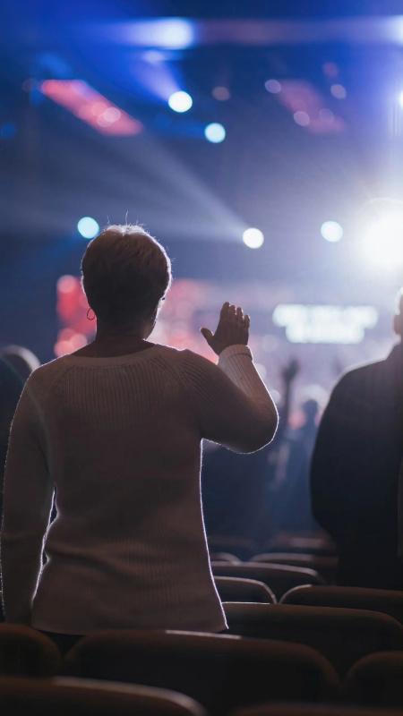 Candid moment from a live event with a crowd in the background